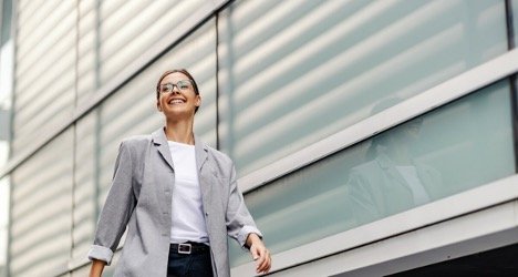 Woman walking in front of an office building